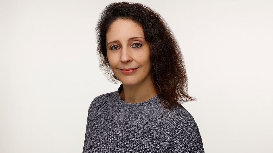 Portrait photo of female alumna looking directly at the camera.